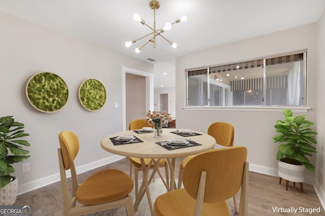 dining room featuring a chandelier and hardwood / wood-style flooring