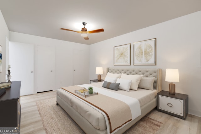 bedroom with light hardwood / wood-style flooring and ceiling fan