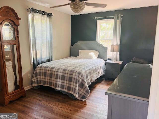 bedroom with ceiling fan and hardwood / wood-style floors