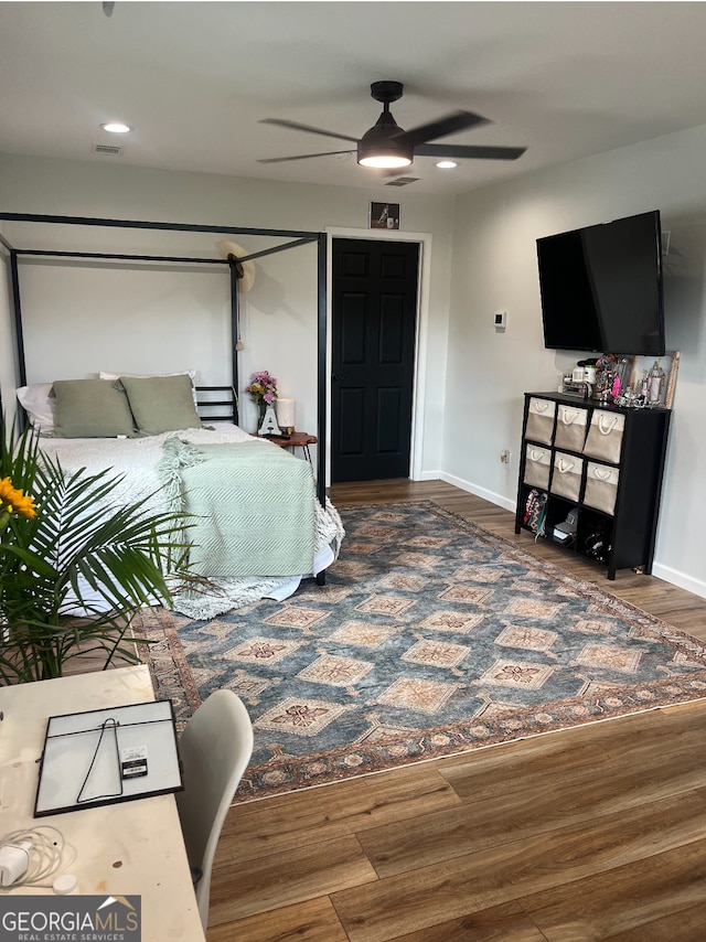 bedroom featuring hardwood / wood-style floors and ceiling fan