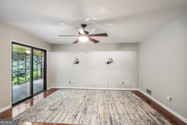 empty room featuring hardwood / wood-style floors and ceiling fan