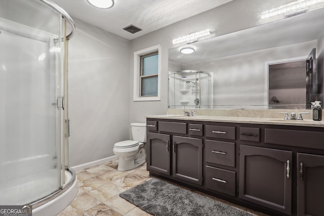 bathroom with vanity, toilet, and walk in shower