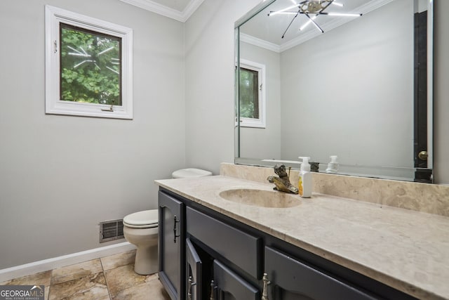 bathroom featuring a chandelier, vanity, toilet, and ornamental molding