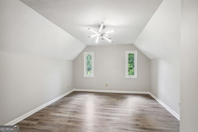 bonus room featuring dark hardwood / wood-style flooring and lofted ceiling