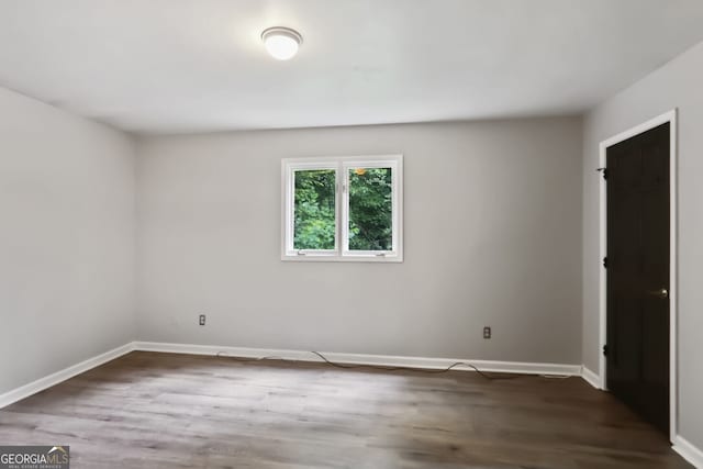 spare room with dark wood-type flooring