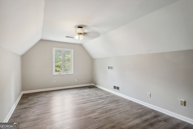 bonus room with dark hardwood / wood-style flooring, vaulted ceiling, and ceiling fan