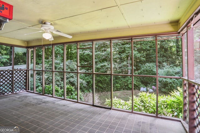 unfurnished sunroom with ceiling fan and a healthy amount of sunlight