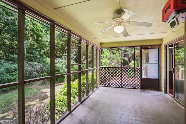 unfurnished sunroom with ceiling fan and a wealth of natural light