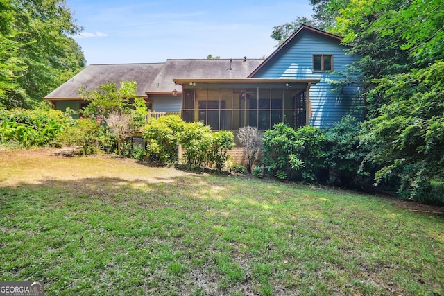 exterior space featuring a lawn and a sunroom