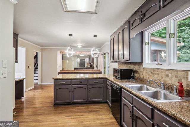 kitchen with kitchen peninsula, crown molding, sink, decorative light fixtures, and black dishwasher