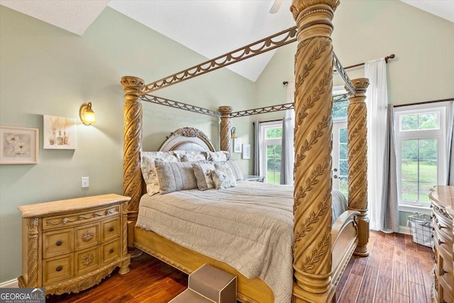 bedroom with dark hardwood / wood-style flooring and lofted ceiling