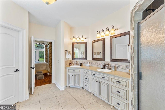 bathroom featuring a shower with shower door, backsplash, and tile patterned floors