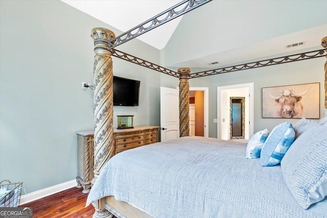 bedroom with dark hardwood / wood-style floors and lofted ceiling