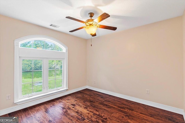 empty room with ceiling fan and dark hardwood / wood-style floors