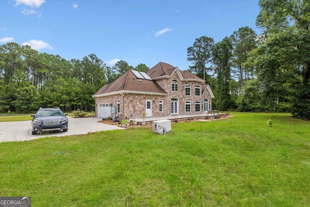 view of front of property featuring a garage and a front lawn