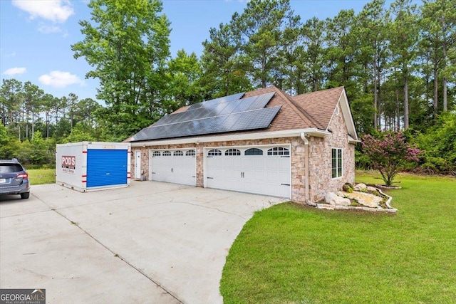 exterior space featuring a lawn, solar panels, and a garage