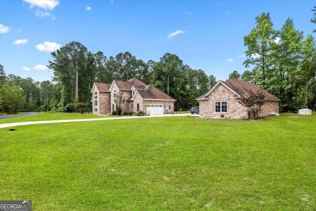 view of front of home with a front lawn and a garage