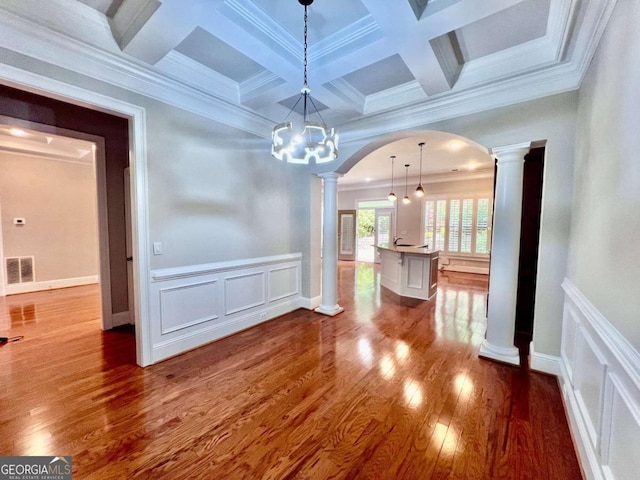 unfurnished dining area featuring ornate columns, dark hardwood / wood-style flooring, coffered ceiling, and ornamental molding