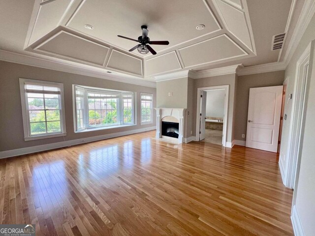 unfurnished living room featuring a healthy amount of sunlight, wood-type flooring, and ceiling fan