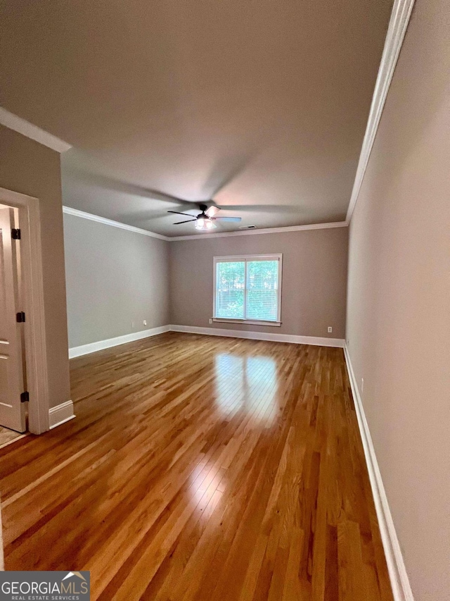 spare room with ceiling fan, hardwood / wood-style flooring, and ornamental molding