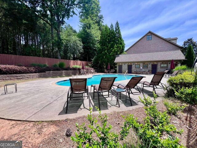 view of swimming pool with a patio