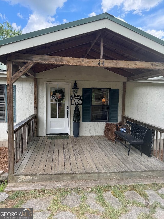 view of exterior entry with a deck