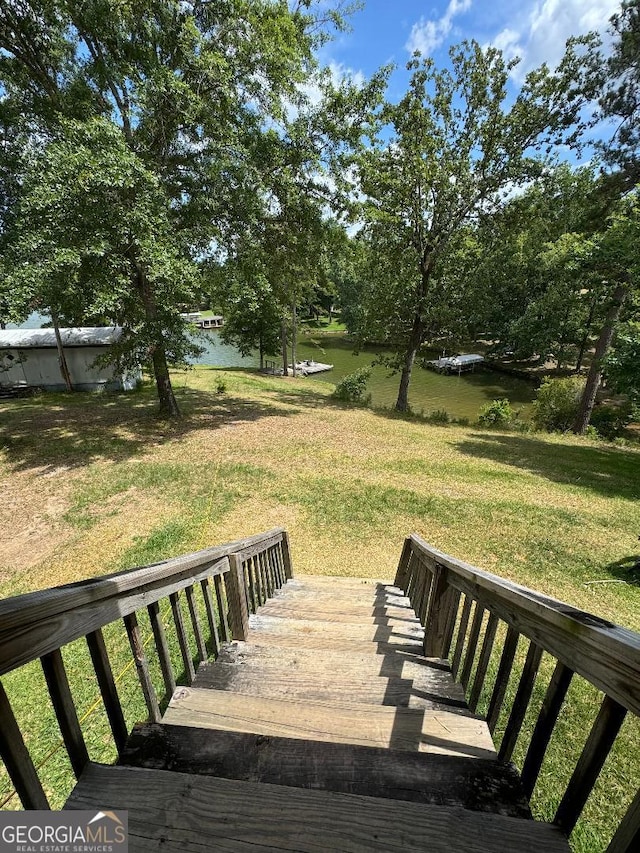 exterior space featuring a water view and a yard