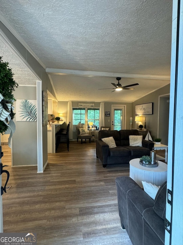 living room featuring ornamental molding, ceiling fan, hardwood / wood-style floors, and a textured ceiling