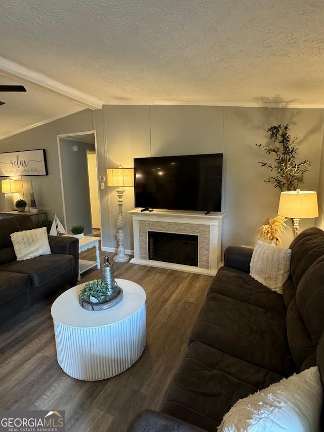 living room featuring a textured ceiling, hardwood / wood-style flooring, and vaulted ceiling