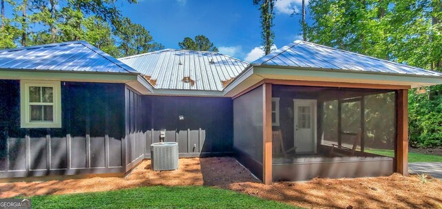 back of property featuring central AC and a sunroom