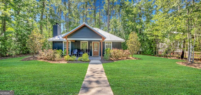 bungalow-style home with a front lawn and a porch