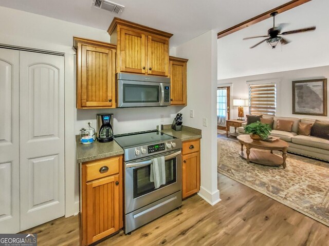 kitchen featuring ceiling fan, light wood-type flooring, and appliances with stainless steel finishes