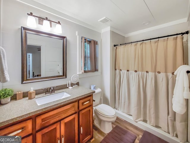 bathroom with crown molding, walk in shower, hardwood / wood-style floors, vanity, and toilet