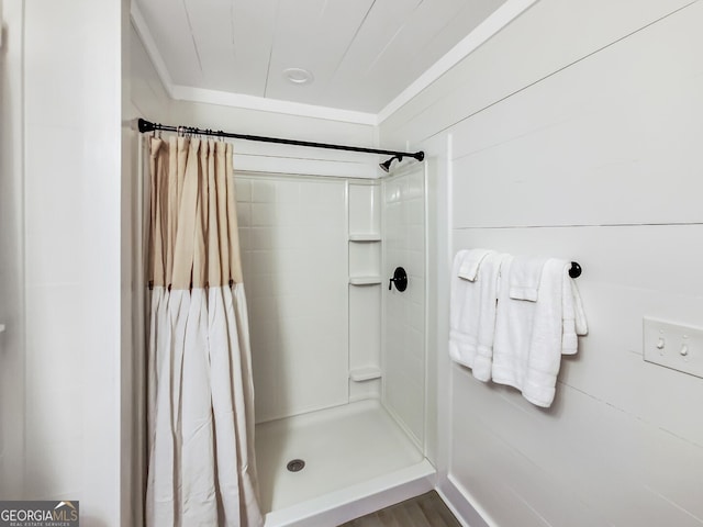 bathroom featuring walk in shower and hardwood / wood-style flooring