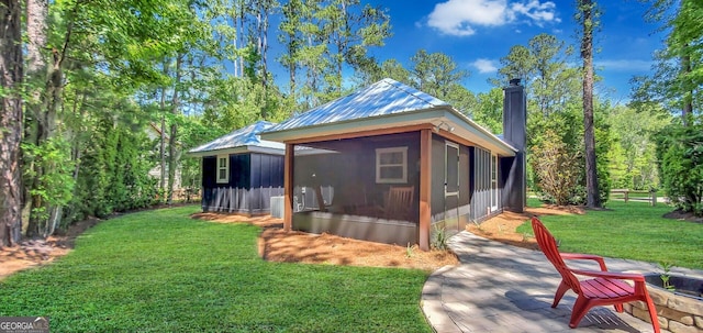 rear view of property with a patio area and a lawn