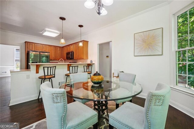 dining area with dark hardwood / wood-style flooring and ornamental molding