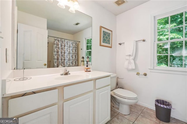 bathroom featuring vanity, toilet, and tile patterned flooring