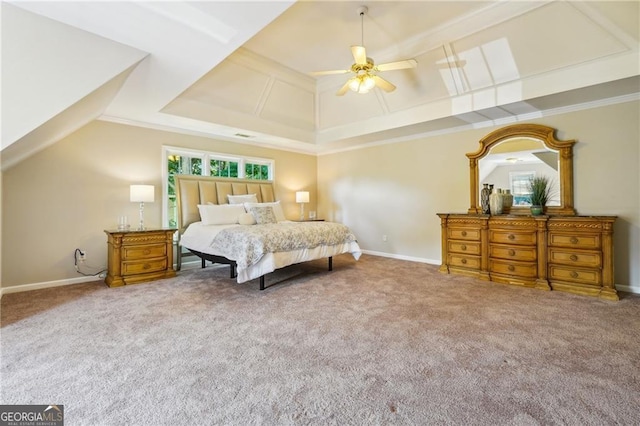 carpeted bedroom with crown molding, ceiling fan, and a raised ceiling