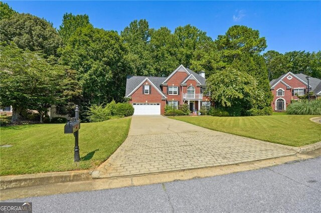 view of front of home with a garage and a front yard