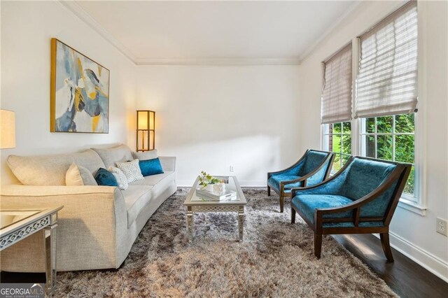 living room with crown molding and hardwood / wood-style floors