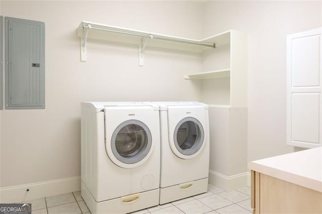 laundry area with washer and clothes dryer and light tile floors