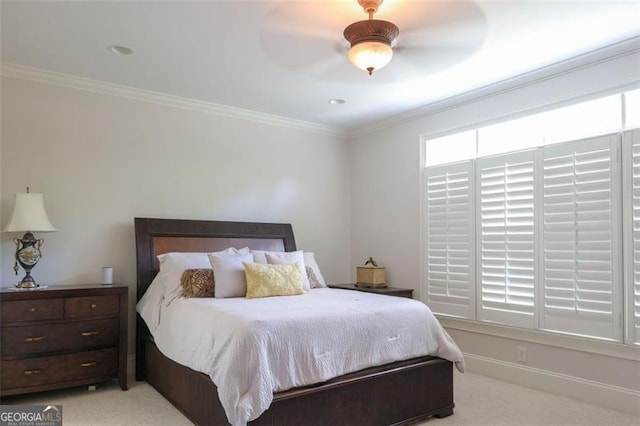 carpeted bedroom featuring ceiling fan and ornamental molding