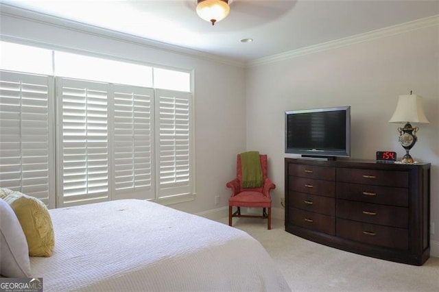 carpeted bedroom with ornamental molding and ceiling fan