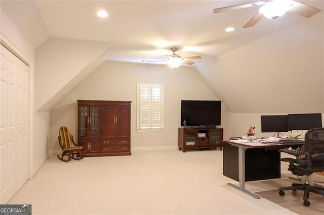 office space featuring carpet, ceiling fan, and vaulted ceiling