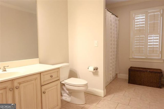 bathroom with tile floors, ornamental molding, vanity, and toilet