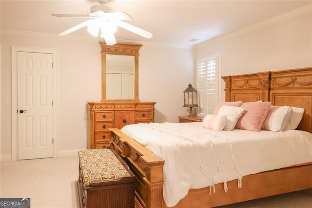 bedroom featuring ornamental molding, ceiling fan, and carpet floors