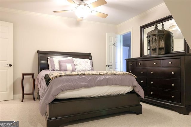 carpeted bedroom with ornamental molding and ceiling fan