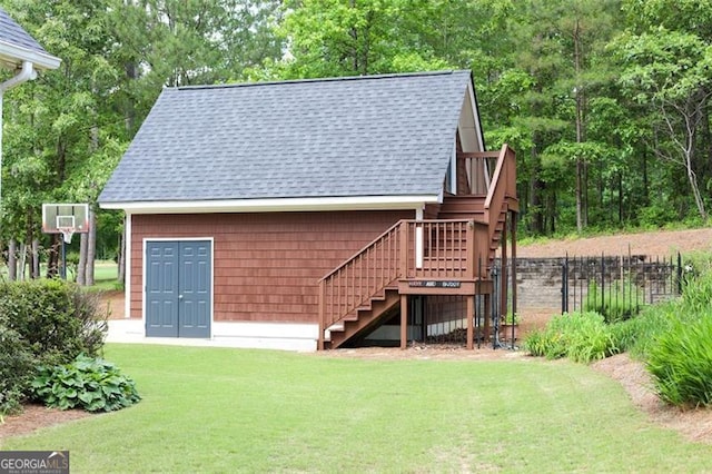 back of house featuring a deck and a lawn