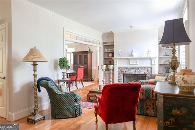 living room with wood-type flooring, a fireplace, and crown molding