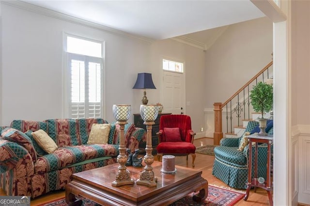 living room with crown molding and hardwood / wood-style floors